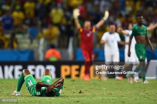 Dejected Ismael Diomande of the Ivory Coast lies on the field after being defeated by Greece 2-1 during the 2014 FIFA World Cup Brazil Group C match...