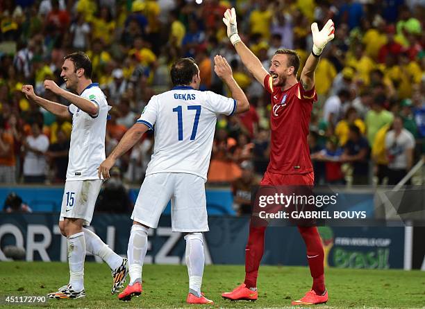 Greece's defender Vasilis Torosidis, Greece's forward Fanis Gekas and Greece's goalkeeper Panagiotis Glykos celebrate after winning the Group C...