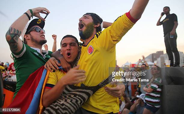 Colombia supporters celebrate after their first goal against Japan while watching at the FIFA Fan Fest on Copacabana Beach on June 24, 2014 in Rio de...
