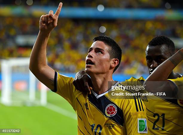 James Rodriguez of Colombia celebrates scoring his team's fourth goal with his teammates during the 2014 FIFA World Cup Brazil Group C match between...