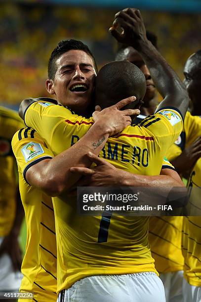 James Rodriguez of Colombia celebrates scoring his team's fourth goal with his teammate Pablo Armero of Colombia during the 2014 FIFA World Cup...