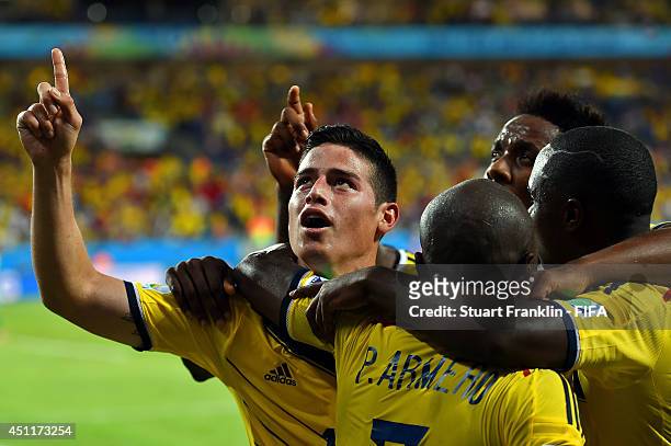 James Rodriguez of Colombia celebrates scoring his team's fourth goal with his teammates during the 2014 FIFA World Cup Brazil Group C match between...