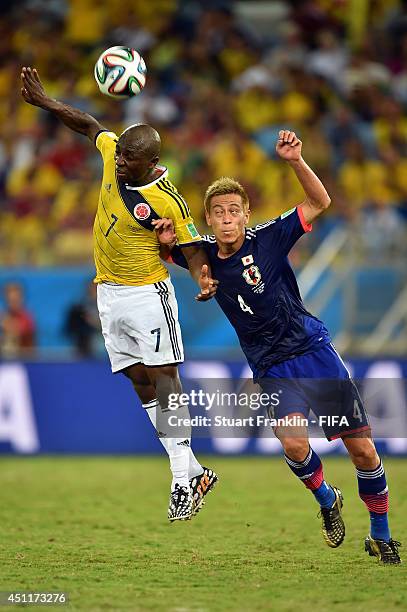 Pablo Armero of Colombia and Keisuke Honda of Japan compete for the ball during the 2014 FIFA World Cup Brazil Group C match between Japan and...