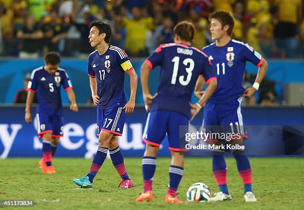 Makoto Hasebe, Yoshito Okubo and Yoichiro Kakitani of Japan wait to kick off after a goal during the 2014 FIFA World Cup Brazil Group C match between...