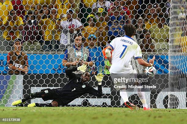Giorgos Samaras of Greece scores his team's second goal on a penalty kick past Boubacar Barry of the Ivory Coast during the 2014 FIFA World Cup...