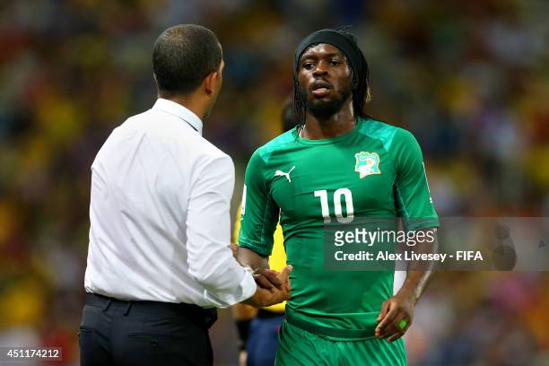 Gervinho of the Ivory Coast shakes hands with head coach Sabri Lamouchi during the 2014 FIFA World Cup Brazil Group C match between Greece and Cote...