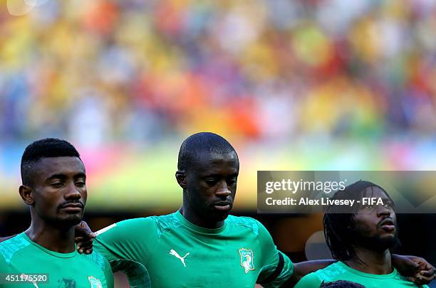 Salomon Kalou, Yaya Toure and Gervinho of the Ivory Coast look on during the National Anthem prior to the 2014 FIFA World Cup Brazil Group C match...