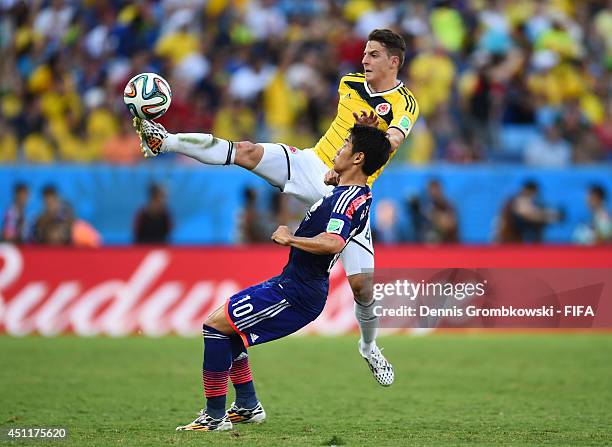 Santiago Arias of Colombia and Shinji Kagawa of Japan compete for the ball during the 2014 FIFA World Cup Brazil Group C match between Japan and...