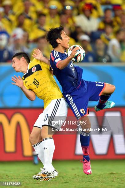 Makoto Hasebe of Japan and James Rodriguez of Colombia compete for the ball during the 2014 FIFA World Cup Brazil Group C match between Japan and...
