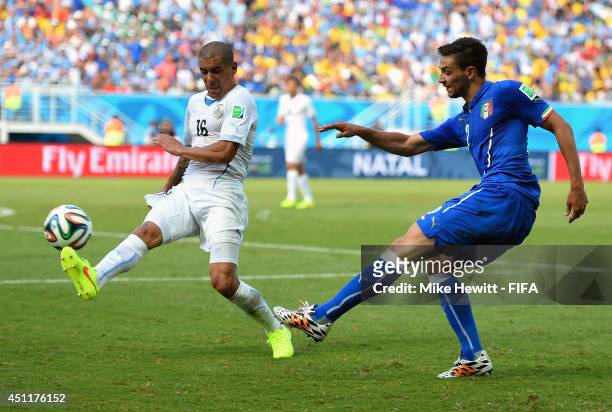 Maximilliano Pereira of Uruguay attempts to block Mattia De Sciglio of Italy during the 2014 FIFA World Cup Brazil Group D match between Italy and...