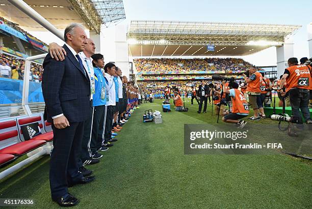 Head coach Alberto Zaccheroni of Japan and his team staffs line up for the national anthems prior to the 2014 FIFA World Cup Brazil Group C match...
