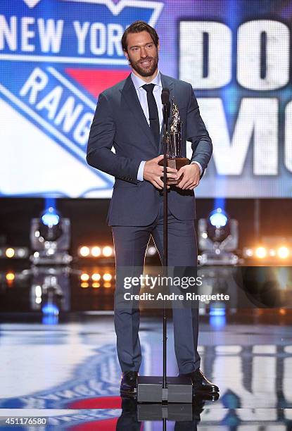 Dominic Moore of the New York Rangers speaks onstage after winning the Bill Masterton Memorial Trophy during the 2014 NHL Awards at the Encore...