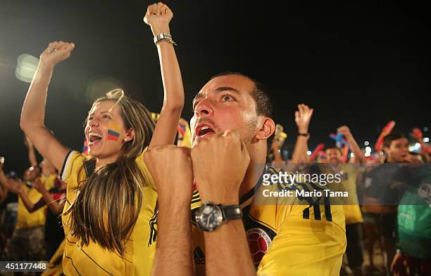 Colombia supporters celebrate after they defeated Japan while watching at the FIFA Fan Fest on Copacabana Beach on June 24, 2014 in Rio de Janeiro,...