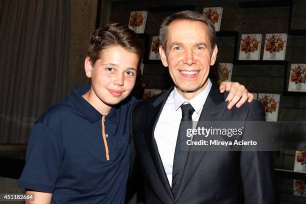 Artist Jeff Koons poses with son Sean Koons at Jeff Koons: A Retrospective at The Whitney Museum of American Art on June 24, 2014 in New York City.