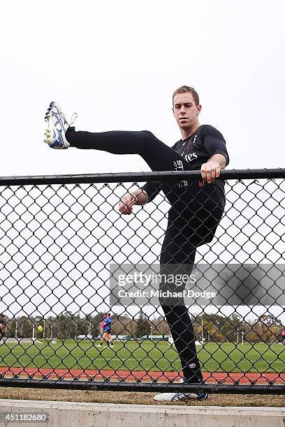 Nick Maxwell, recovering from a calf muscle injury, hops over the fence after a Collingwood Magpies training session at Westpac Centre on June 25,...