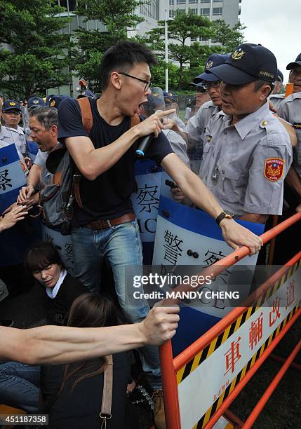 One of the student protest leaders, Lin Fei-fan , and a group of slogan-chanting demonstrators clash with riot police while attempting to push their...