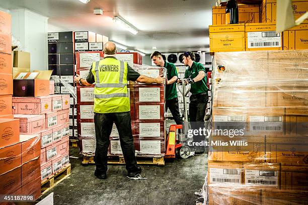 Workers deliver a palette of champagne during day four of Royal Ascot at Ascot Racecourse on June 20, 2014 in Ascot, England.