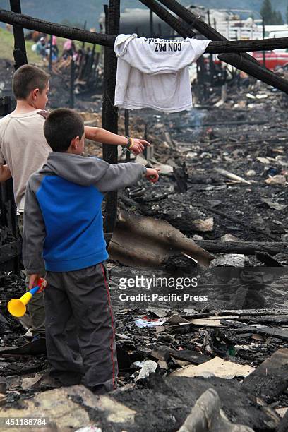 Two boys looking in the rubble of a fire that occurred on the evening of June the 23rd in a poor neighborhood located in northwestern Bogotá; 120...