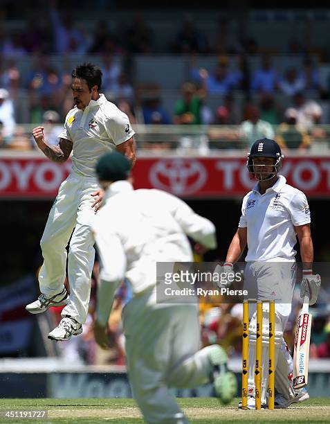 Mitchell Johnson of Australia celebrates after taking the wicket of Jonathan Trott of England during day two of the First Ashes Test match between...