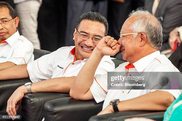 Najib Razak, Malaysia's prime minister, right, speaks with Hishammuddin Hussein, Malaysia's acting transport minister, center, during the launch of...