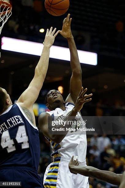 Chris Otule of the Marquette Golden Eagles pulls up with the jump hook in the first half against the New Hampshire Wildcats at BMO Harris Bradley...