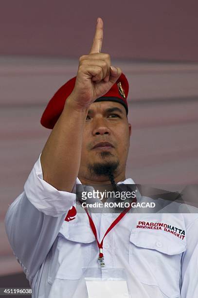In this photograph taken on June 22 Indonesian rock star Ahmad Dhani makes a gesture as he joins presidential candidate Prabowo Subianto on stage...