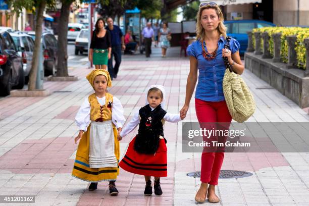 Contrast of modern and traditional outfits at fiesta at Villaviciosa in Asturias, Northern Spain