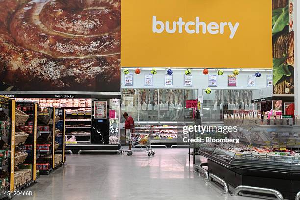 Customer browses a display of chilled meats for sale inside a Makro cash and carry store, operated by Massmart Holdings Ltd., in Alberton, South...