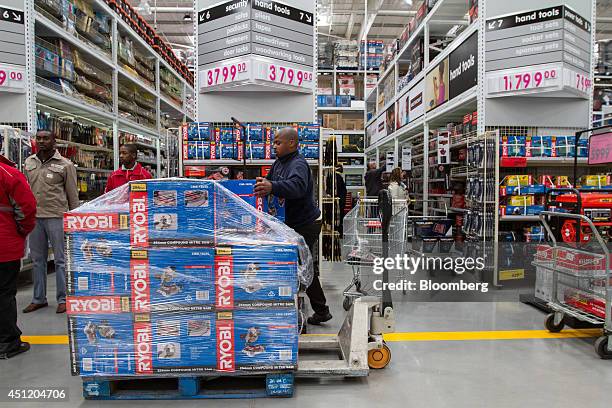 An employee restocks a display of Ryobi Machinery Co. Power tools inside a Makro cash and carry store, operated by Massmart Holdings Ltd., in...