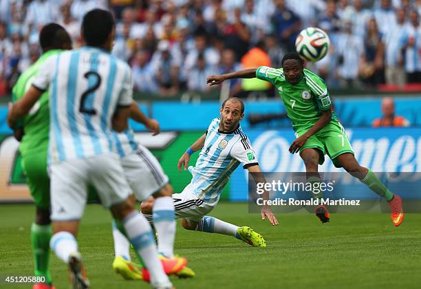 Ahmed Musa of Nigeria shoots and scores his team's first goal against Pablo Zabaleta of Argentina during the 2014 FIFA World Cup Brazil Group F match...