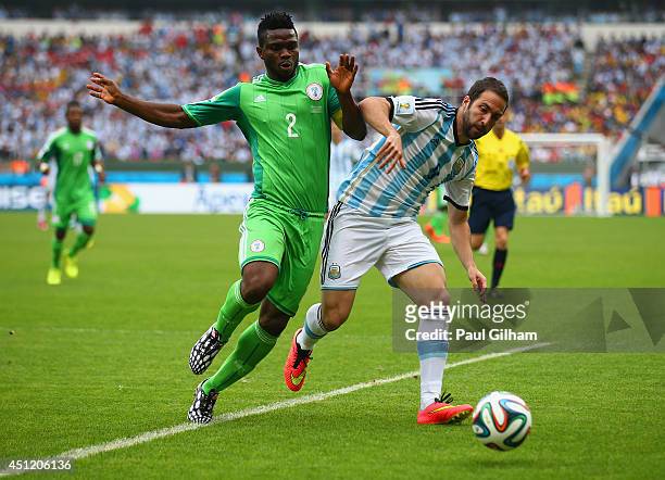 Joseph Yobo of Nigeria challenges Gonzalo Higuain of Argentina during the 2014 FIFA World Cup Brazil Group F match between Nigeria and Argentina at...