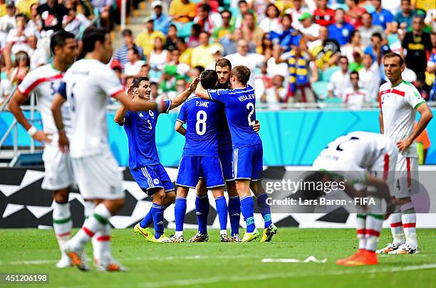 Edin Dzeko of Bosnia and Herzegovina celebrates scoring his team's first goal with his teammates during the 2014 FIFA World Cup Brazil Group F match...