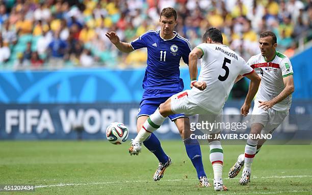 Bosnia-Herzegovina's forward Edin Dzeko , Iran's defender Amir Hossein Sadeghi and Iran's defender Jalal Hosseini vie for the ball during a Group F...