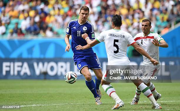 Bosnia-Herzegovina's forward Edin Dzeko Iran's defender Amir Hossein Sadeghi and Iran's defender Jalal Hosseini vie for the ball during a Group F...