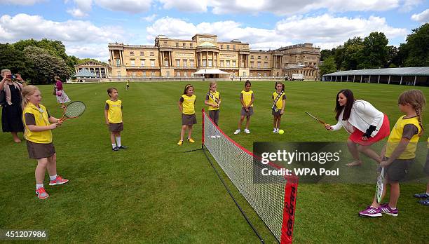 Brownies play tennis with injured British tennis player Laura Robson at a tea party hosted by Sophie, Countess of Wessex at Buckingham Palace,...