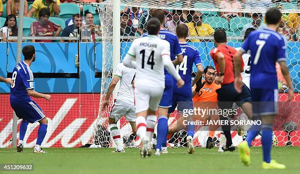 Bosnia-Herzegovina's midfielder Miralem Pjanic kicks to score his team's second goal past Iran's goalkeeper Alireza Haghighi during a Group F...