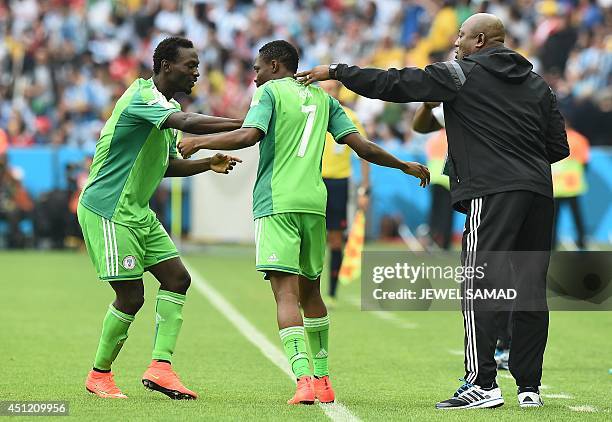 Nigeria's coach Stephen Keshi and Nigeria's defender Juwon Oshaniwa congratulate Nigeria's forward Ahmed Musa after he scored his second goal during...