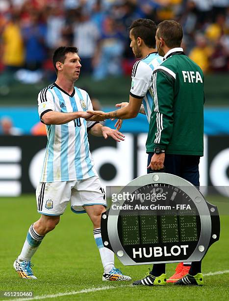 Lionel Messi of Argentina shakes hands with Ricardo Alvarez of Argentina as he is replaced during the 2014 FIFA World Cup Brazil Group F match...