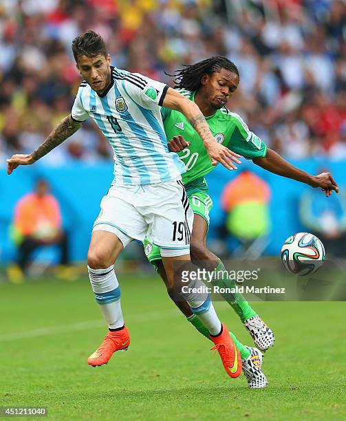 Ricardo Alvarez of Argentina is challenged by Okechukwu Uchebo of Nigeria during the 2014 FIFA World Cup Brazil Group F match between Nigeria and...