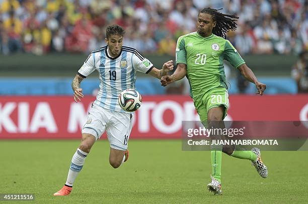 Argentina's midfielder Ricky Alvarez and Nigeria's forward Michael Uchebo vie for the ball during a Group F football match between Nigeria and...