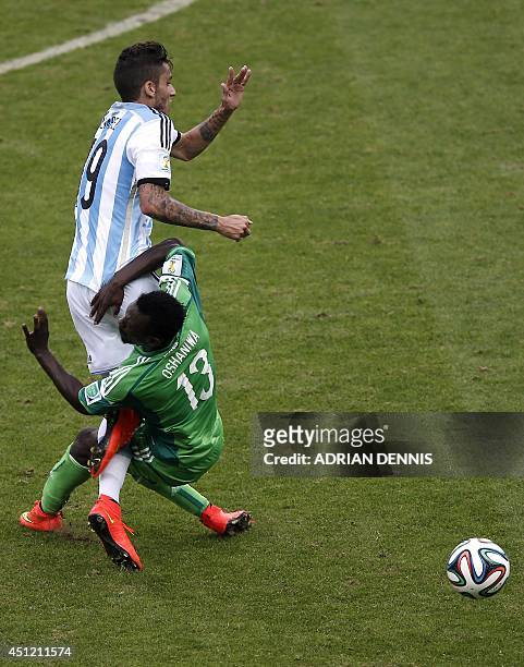 Argentina's midfielder Ricky Alvarez is challenged by Nigeria's defender Juwon Oshaniwa for the ball during the Group F football match between...
