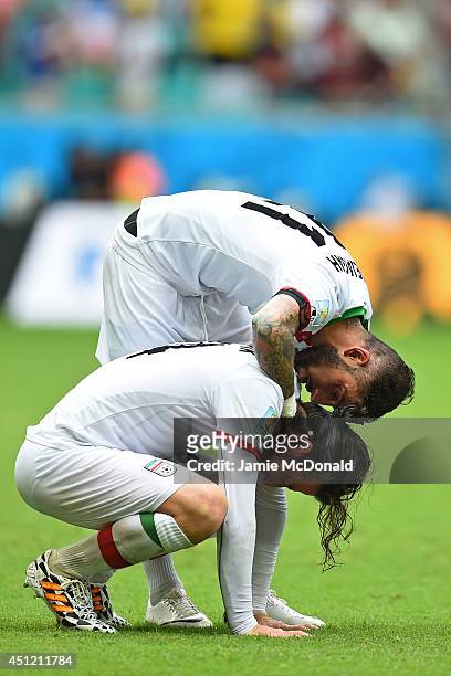 Ashkan Dejagah consoles Andranik Teymourian of Iran after a 3-1 defeat in the 2014 FIFA World Cup Brazil Group F match between Bosnia and Herzegovina...