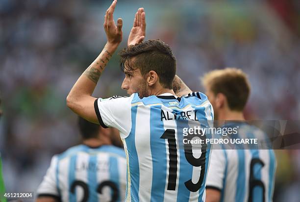 Argentina's midfielder Ricky Alvarez claps at the end of the Group F football match between Nigeria and Argentina at the Beira-Rio Stadium in Porto...