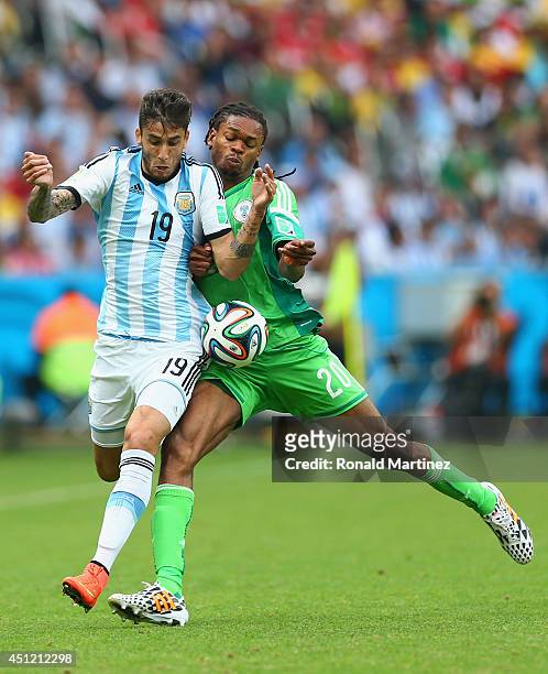 Ricardo Alvarez of Argentina and Okechukwu Uchebo of Nigeria collide during the 2014 FIFA World Cup Brazil Group F match between Nigeria and...