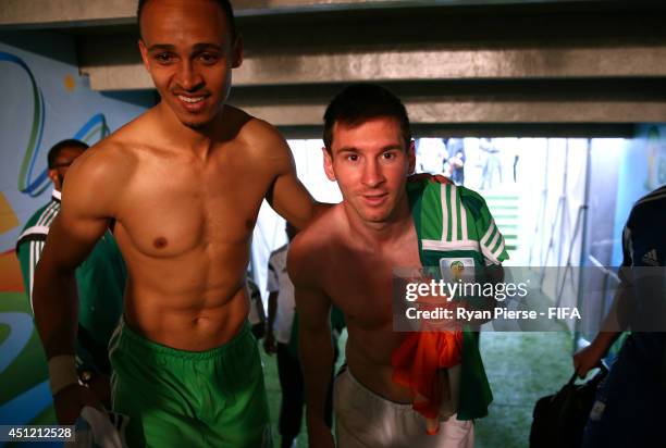 Lionel Messi of Argentina and Peter Odemwingie of Nigeria walk in the tunnel after the 2014 FIFA World Cup Brazil Group F match between Nigeria and...