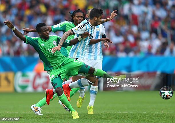 Ogenyi Onazi of Nigeria competes for the ball with Ricardo Alvarez of Argentina during the 2014 FIFA World Cup Brazil Group F match between Nigeria...