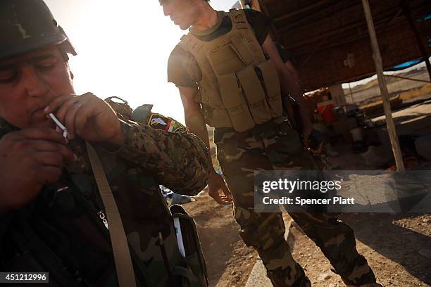 Kurdish soldiers with the Peshmerga keep guard near the frontline with Sunni militants on the outskirts of Kirkuk, an oil-rich Iraqi city on June 25,...