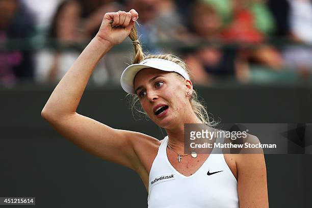 Naomi Broady of Great Britain pulls her ponytail during her defeat in her Ladies' Singles second round match against Caroline Wozniacki of Denmark on...