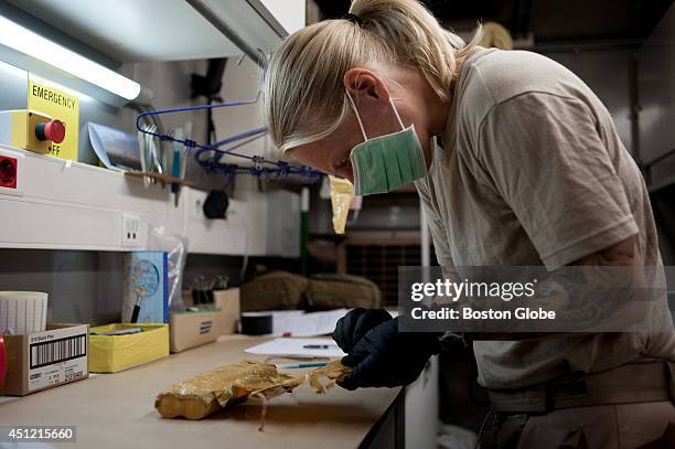 Lena, a Swedish forensic technician working with the International Assistance Force in Kabul examines a detonator from an unexploded Improvised...