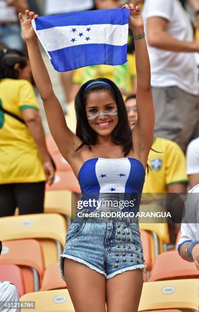 Honduras fan cheers for her team before the start of the Group E football match between Honduras and Switzerland at the Amazonia Arena in Manaus...